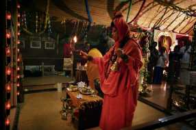 Lalitha Sripalan, dressed in red, performs puja at her temple in Brande, Denmark. Picture: M Q. Fibiger